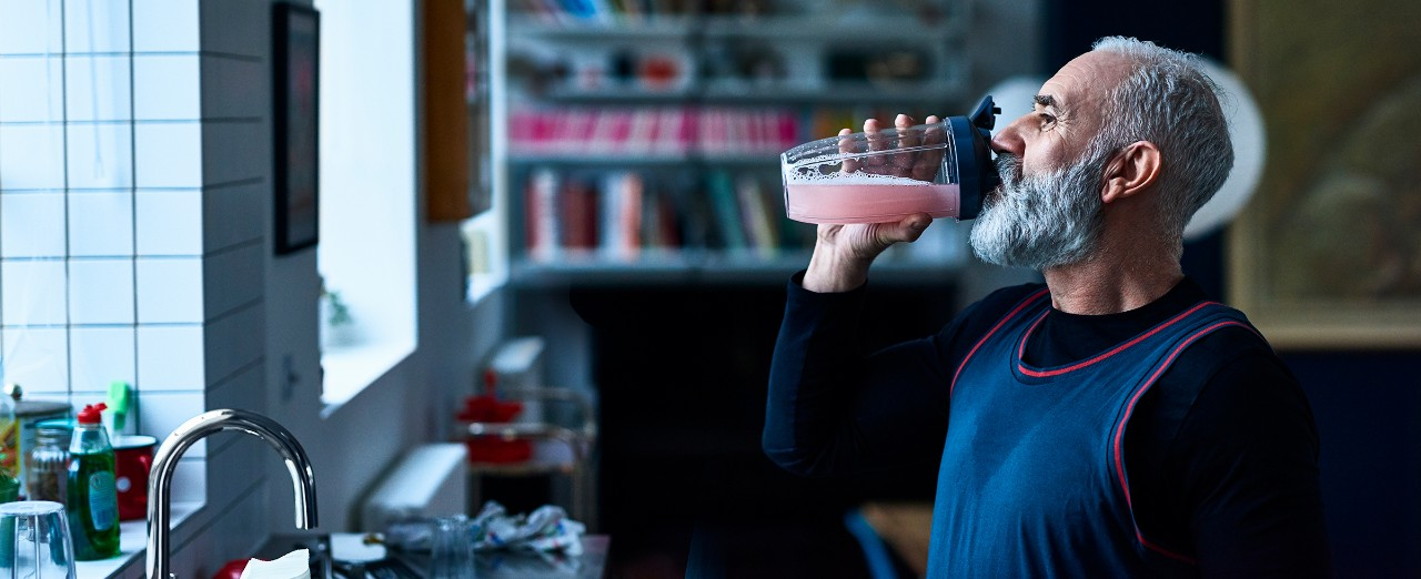 Man drinking juice from sports bottle