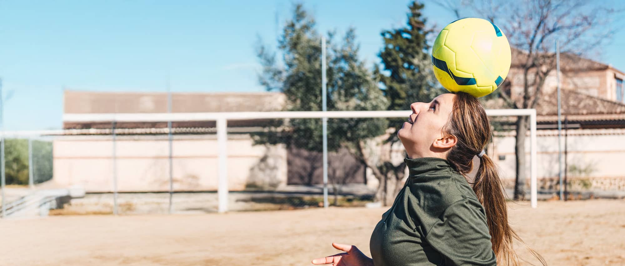 Woman balancing a football on her head