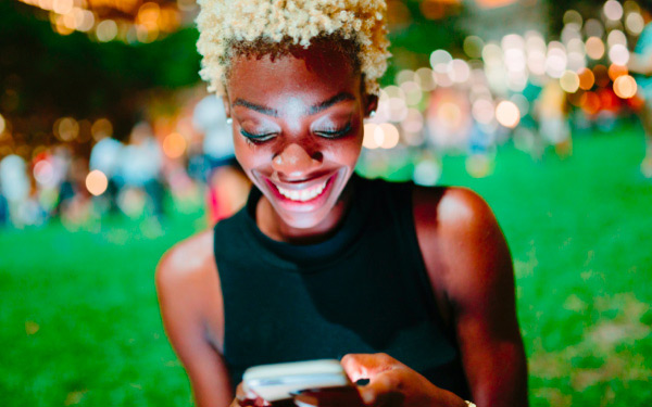 Woman at garden party looking at her phone