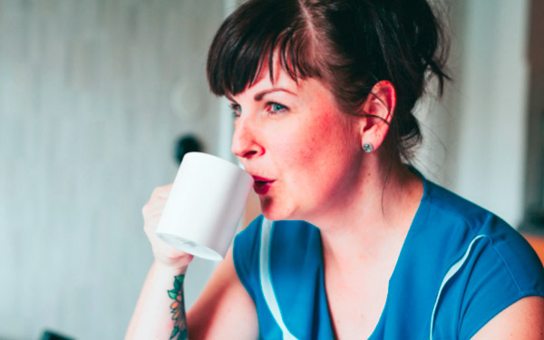 Woman drinking a hot drink from a mug