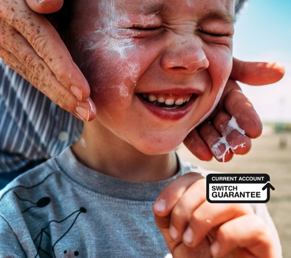 Child having sun cream put on