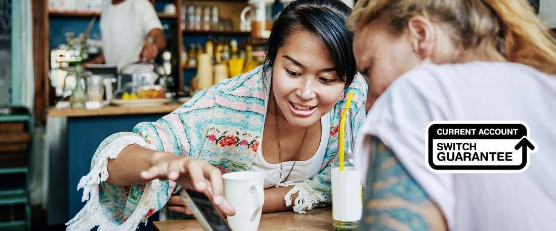 Two women looking at a mobile phone
