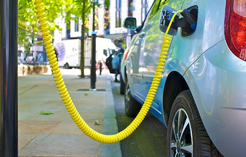 Electric car plugged in charging 