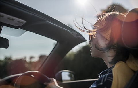 Person driving a convertable car