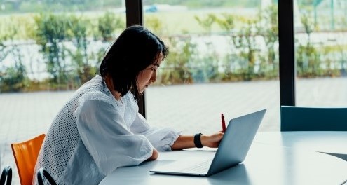 Woman looking at a website on a laptop.