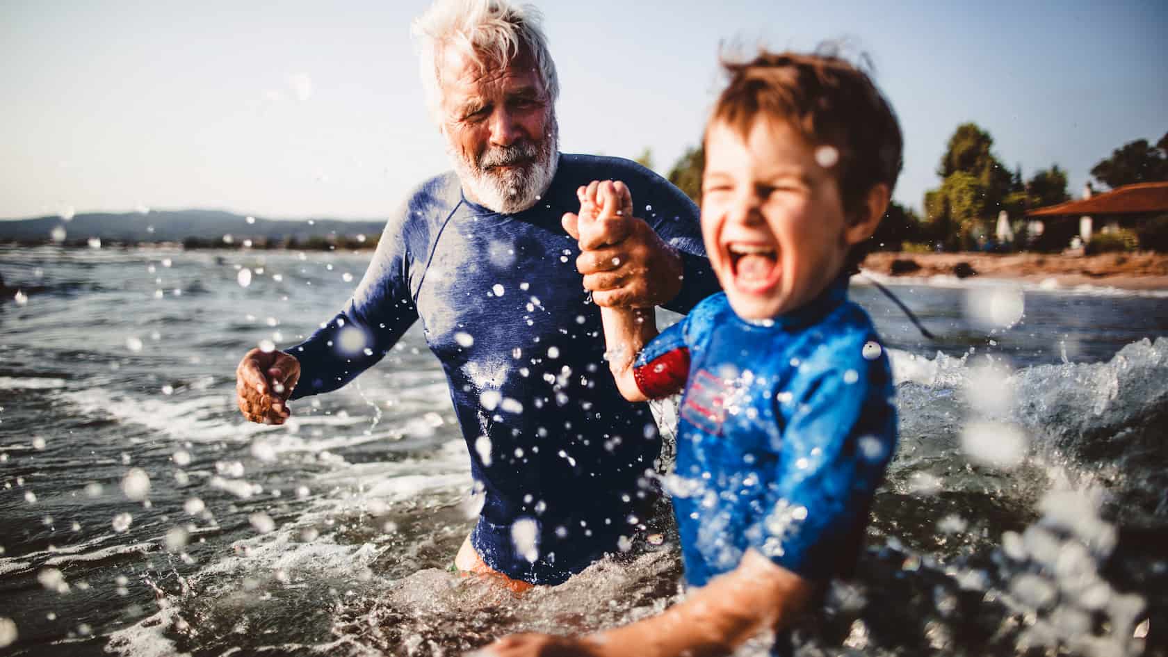 Grandfather and grandson in the sea