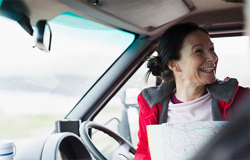 person in car with map