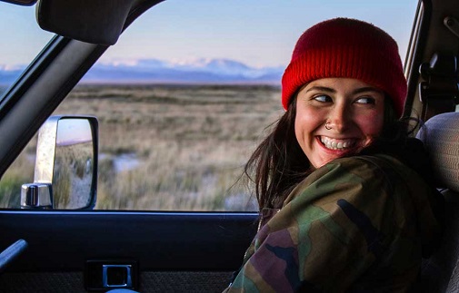 person smiling in parked car