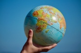 Hand holding globe