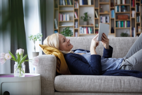 Woman on sofa looking at tablet