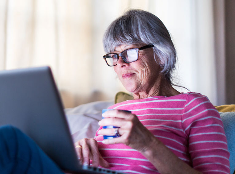 Woman relaxing back while using a laptop
