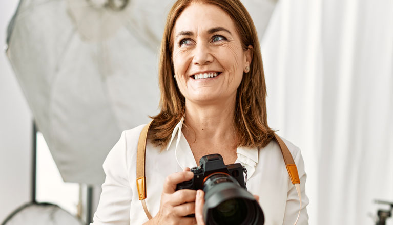 Woman holding camera.