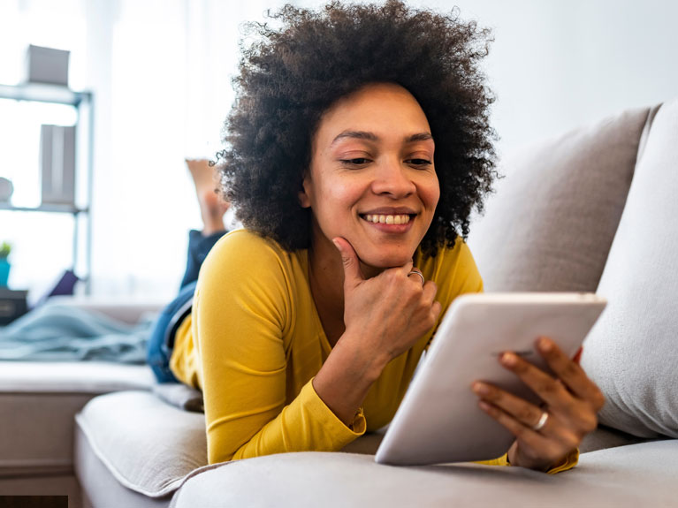 Woman looking at tablet.