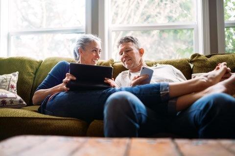 Woman on sofa looking at tablet