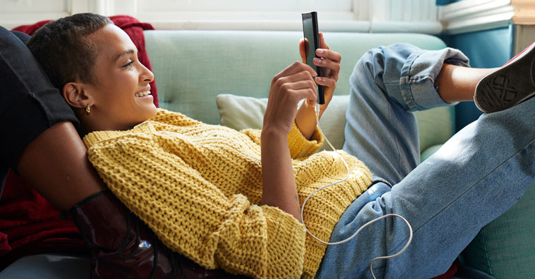 Woman on sofa looking at tablet