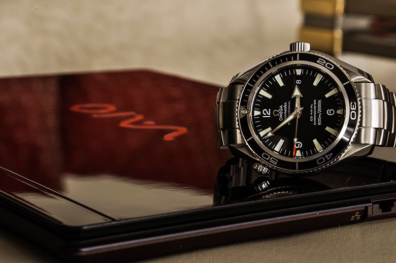 watch and laptop on table