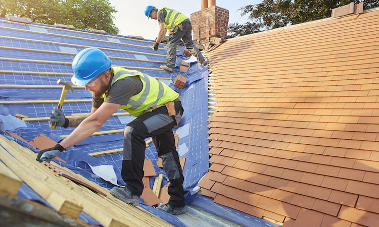 Builder tiling a roof