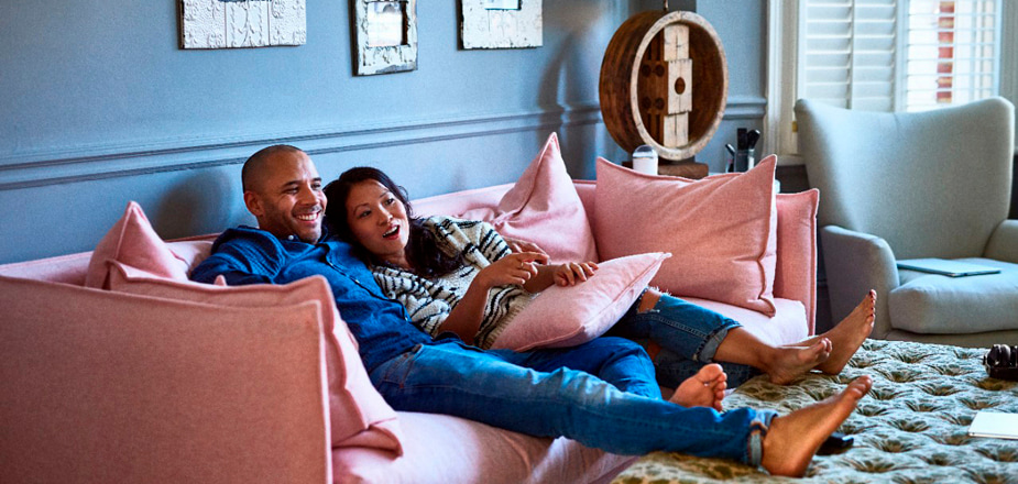 Men and Woment enjoying on sofa