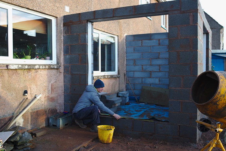 Image of a builder building an extension on a home