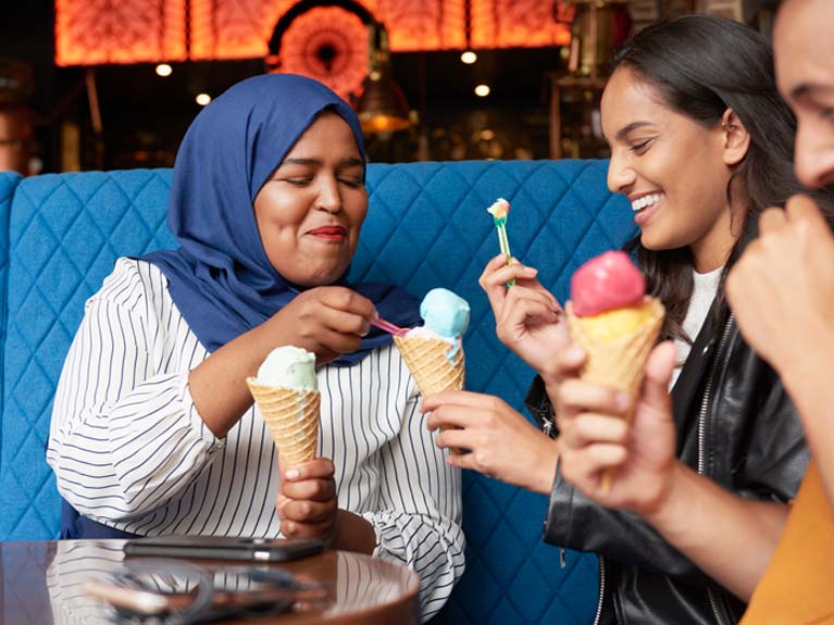 Three people eating ice cream.