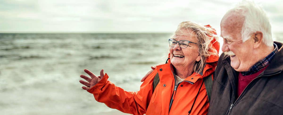 Two elderly people smiling.
