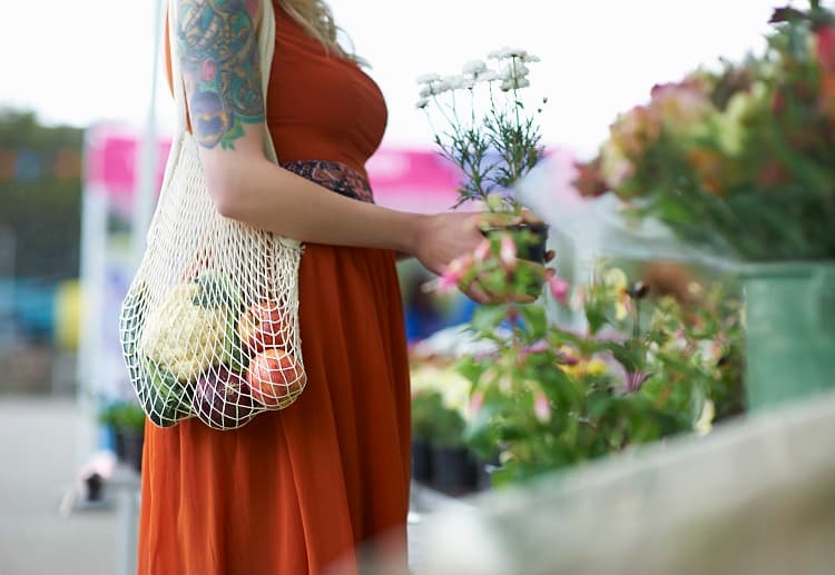 woman in red dress shopping for flowers