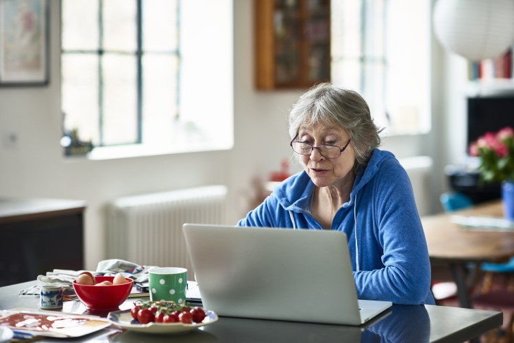 Elderly lady sat with laptop