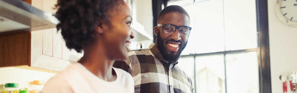 couple smiling at each other in their home