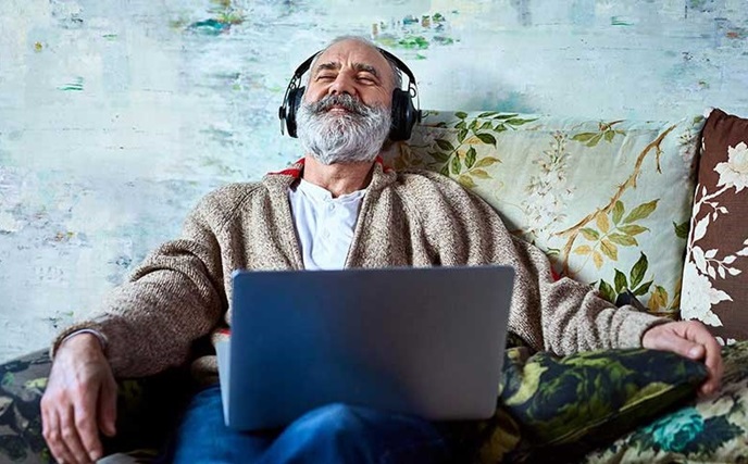 Man with headphones on laptop