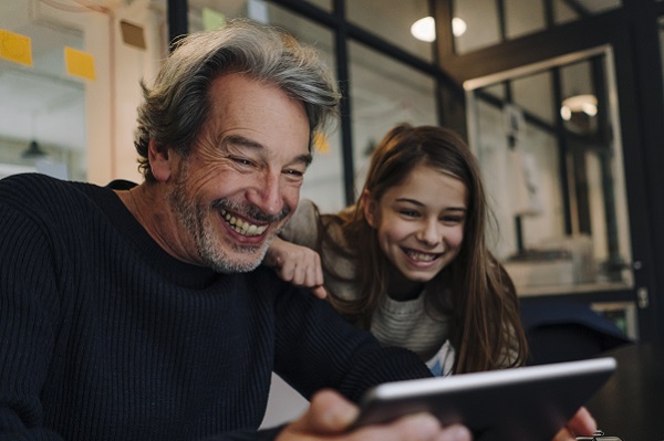 An image of a man and a young girl smiling.